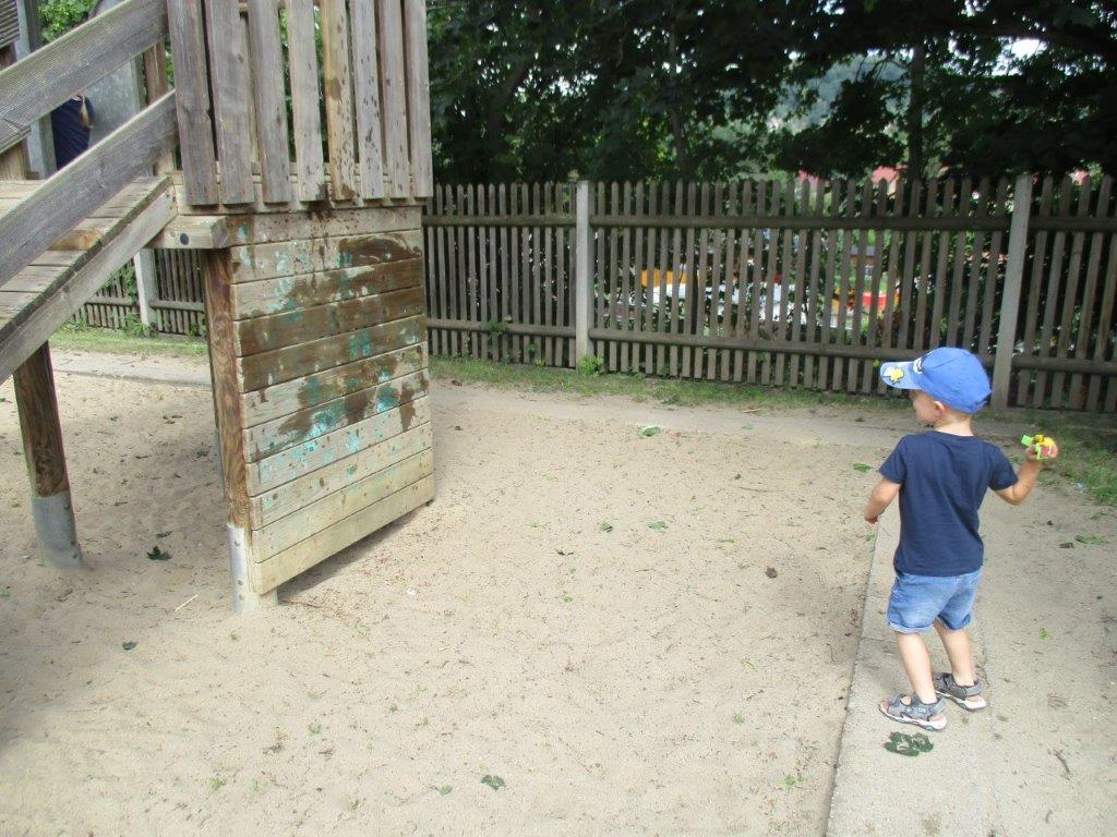 Kindergartenkind wirft mit Wasserblumen